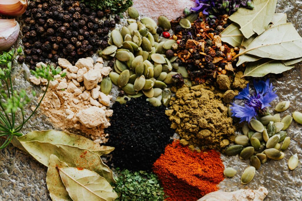 High-quality flat lay of various spices and herbs, perfect for culinary arts or food blogging.