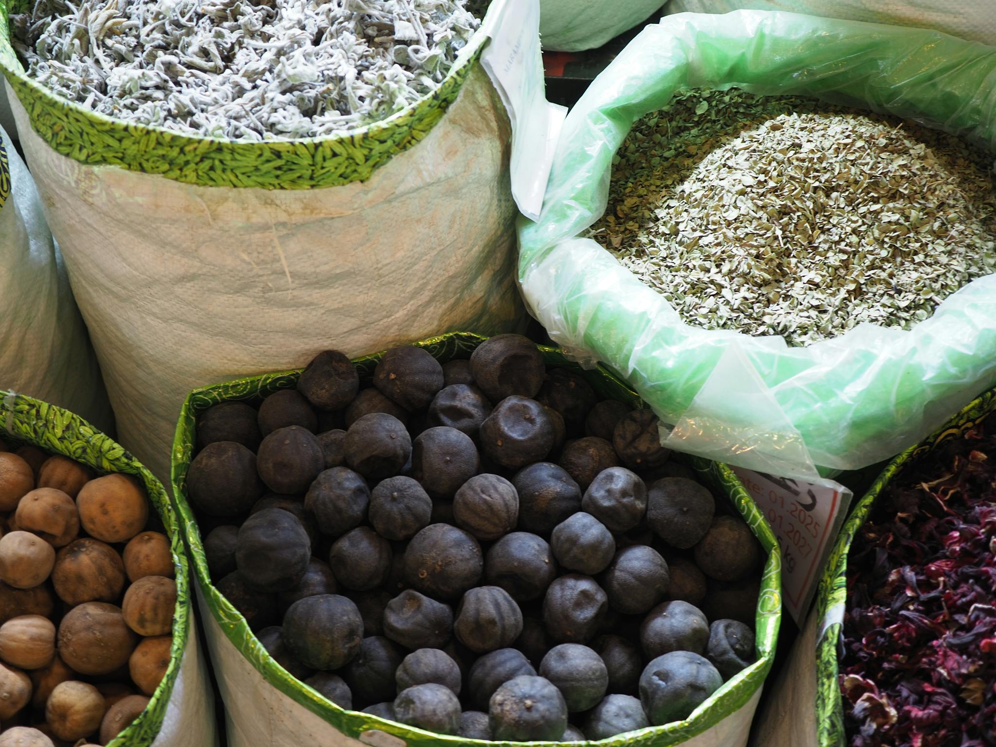 Vibrant market display with dried herbs and fruits in Doha, Qatar. Perfect for authentic cuisine exploration.
